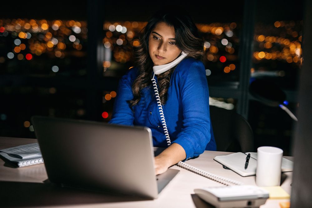 A woman working overtime at her office.